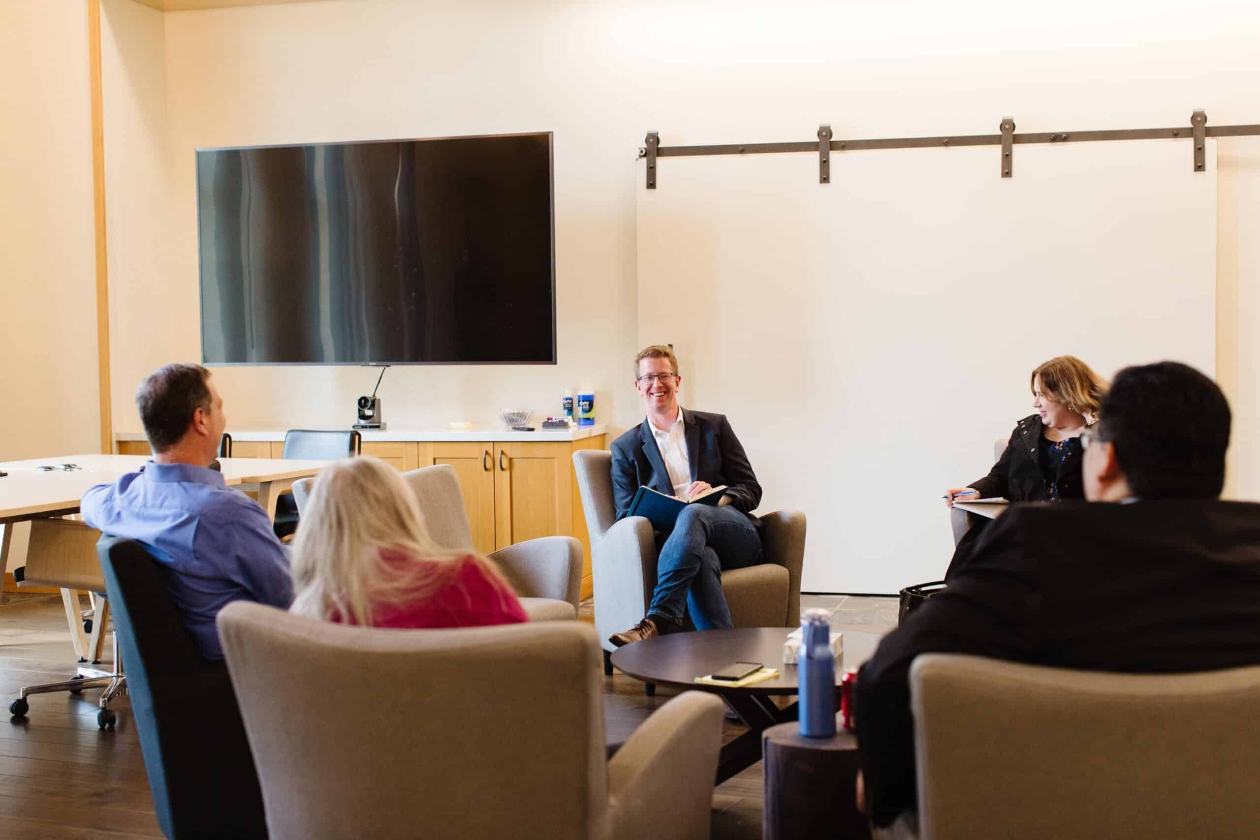 Congressman Derek Kilmer visits Skookum’s Home Office, engaging in a discussion with employees about disability employment, workforce development, and local policy initiatives.