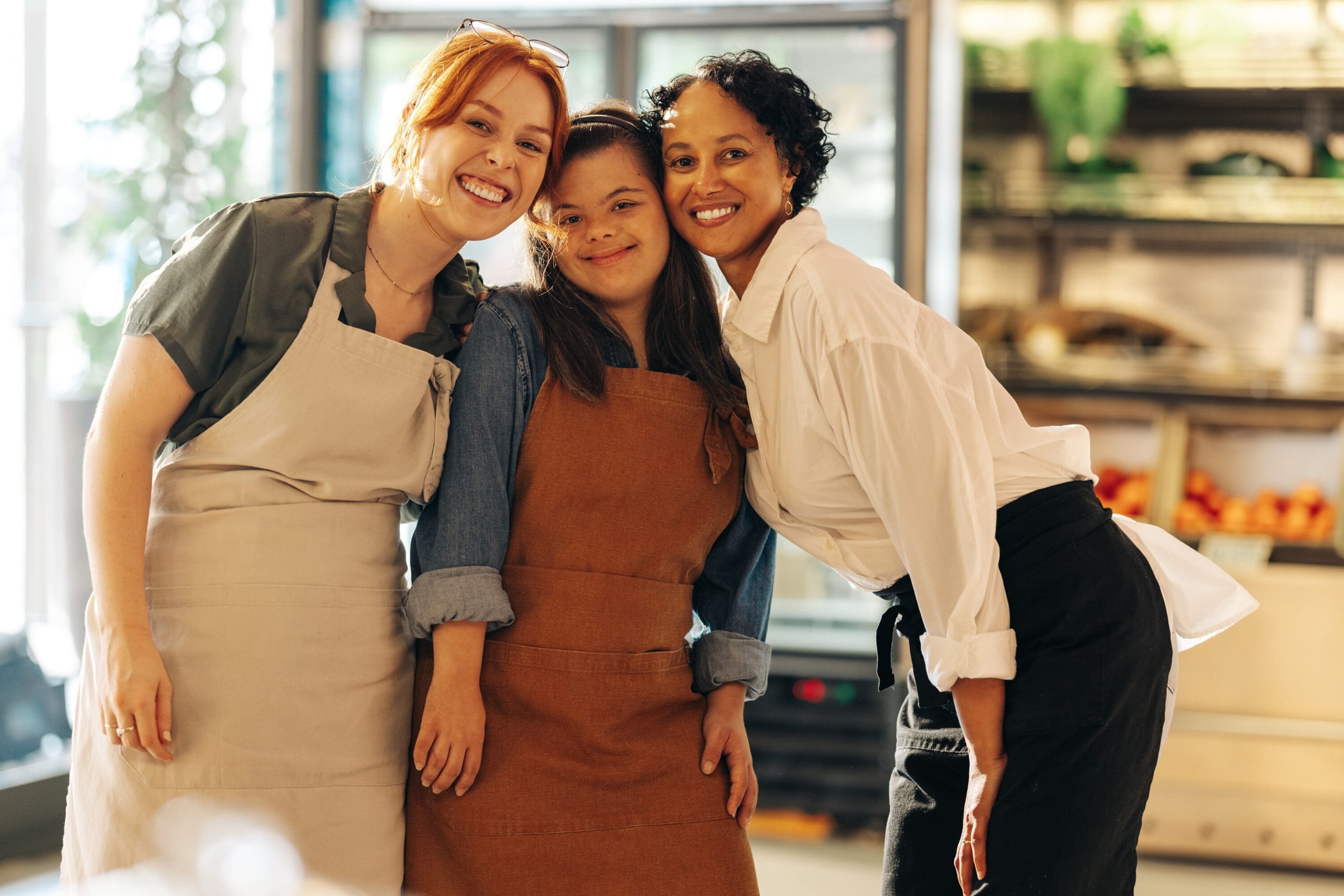 A diverse team collaborates in a bright, welcoming workspace, embodying Tessera’s mission to connect employers with skilled individuals who contribute to a thriving community.